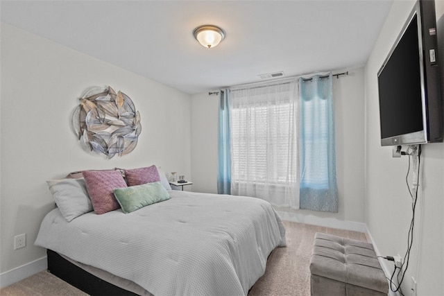 carpeted bedroom with baseboards and visible vents