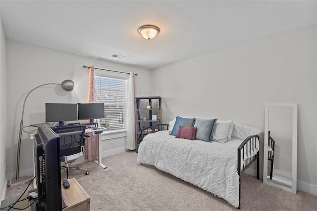 carpeted bedroom with visible vents and baseboards