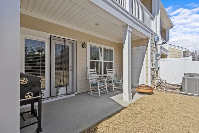 view of patio / terrace featuring central air condition unit and fence