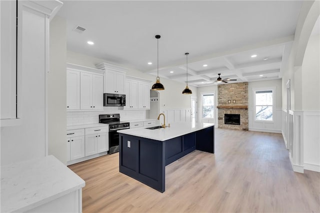 kitchen with visible vents, white cabinets, a sink, range with electric cooktop, and coffered ceiling