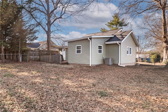 rear view of property with fence and cooling unit