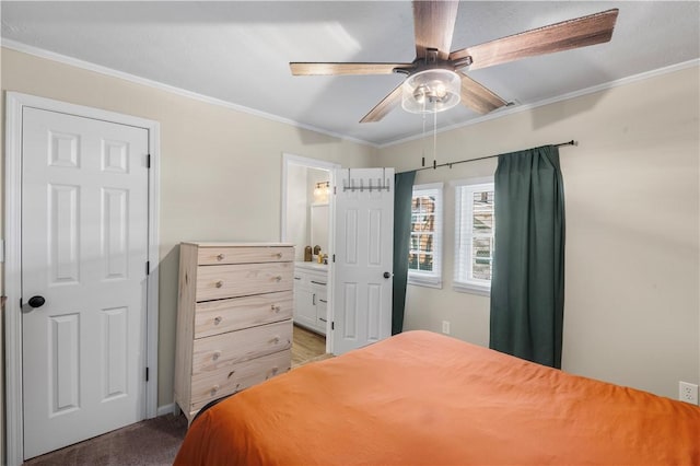 bedroom featuring carpet, crown molding, and ensuite bathroom