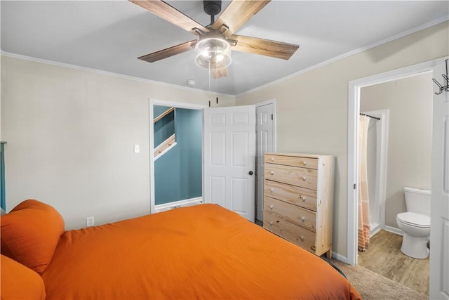 bedroom with baseboards, ceiling fan, wood finished floors, and crown molding