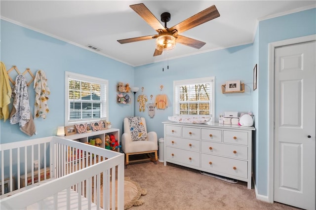 carpeted bedroom featuring a nursery area, ornamental molding, multiple windows, and visible vents