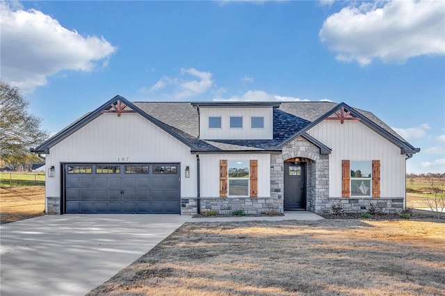 modern inspired farmhouse with an attached garage, stone siding, concrete driveway, and roof with shingles