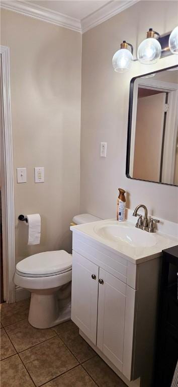 half bath featuring crown molding, vanity, toilet, and tile patterned floors