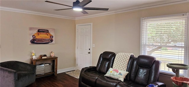 sitting room with baseboards, wood finished floors, a ceiling fan, and crown molding