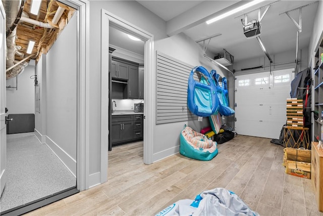 garage featuring a sink and a garage door opener