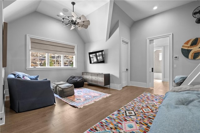 living area with lofted ceiling, recessed lighting, wood finished floors, visible vents, and baseboards