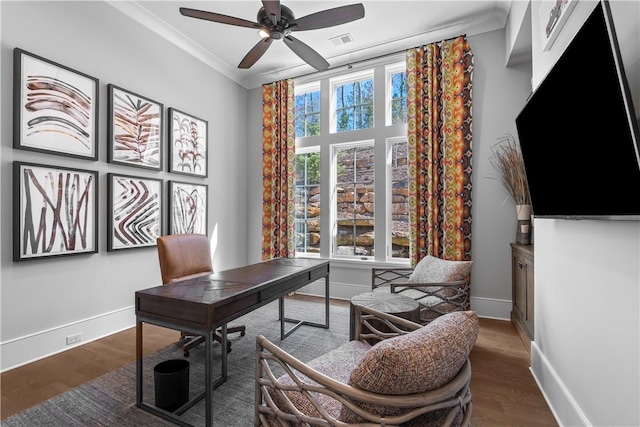 home office with baseboards, visible vents, crown molding, and wood finished floors