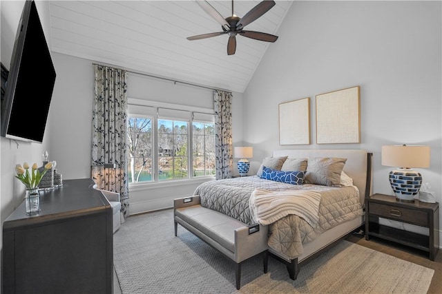 bedroom featuring ceiling fan, high vaulted ceiling, and baseboards