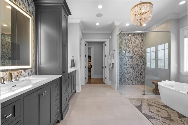 bathroom featuring a notable chandelier, a soaking tub, ornamental molding, vanity, and walk in shower