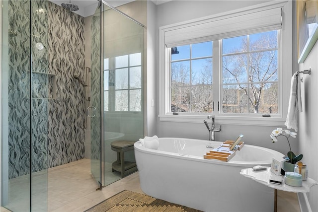 bathroom with a stall shower, plenty of natural light, and a freestanding tub