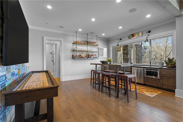 interior space featuring crown molding, recessed lighting, stainless steel dishwasher, wood finished floors, and baseboards