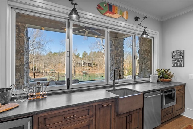 kitchen featuring dark countertops, ornamental molding, a sink, beverage cooler, and dishwasher