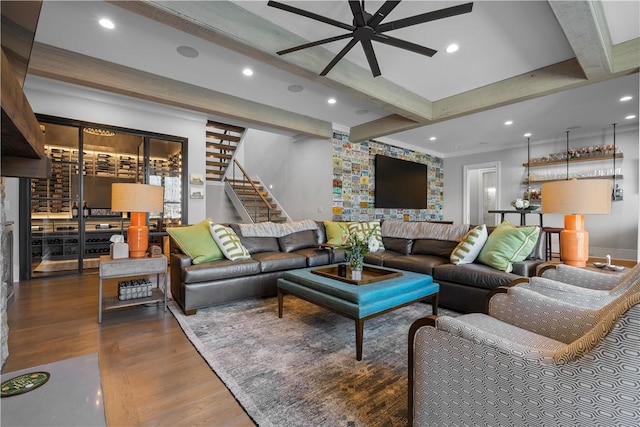 living room with ceiling fan, wood finished floors, stairs, beam ceiling, and recessed lighting