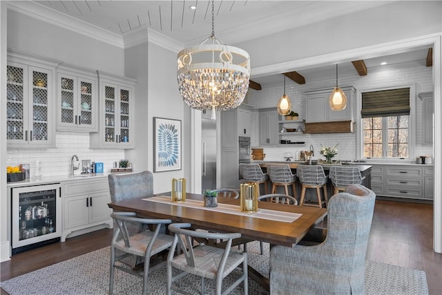 dining room featuring a chandelier, beverage cooler, dark wood-type flooring, ornamental molding, and beam ceiling