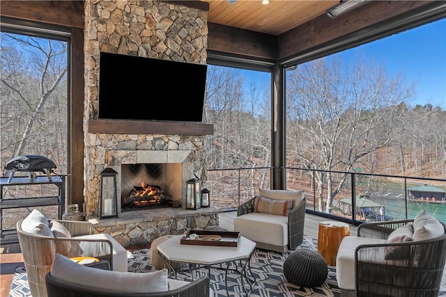 view of patio with an outdoor living space with a fireplace