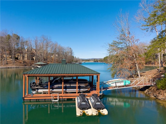 dock area with a water view and boat lift