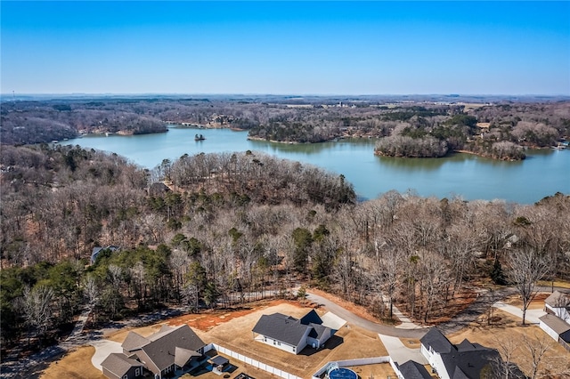 drone / aerial view with a water view and a view of trees