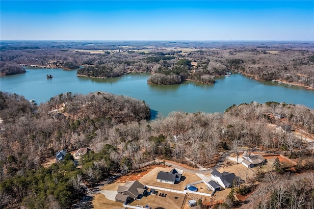 aerial view with a water view and a forest view