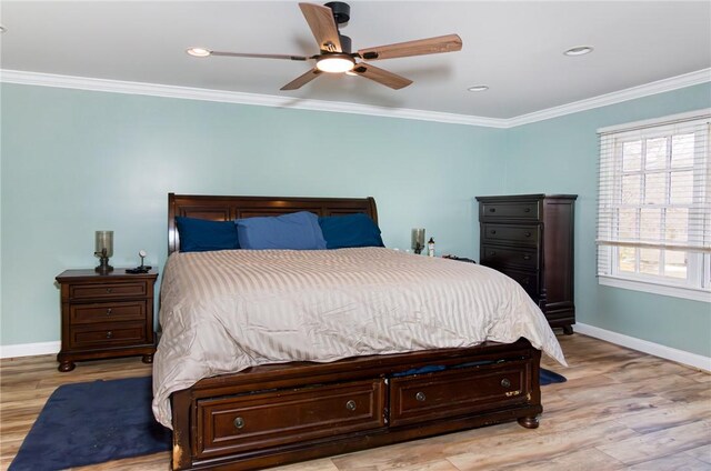 bedroom with ceiling fan, baseboards, crown molding, and wood finished floors