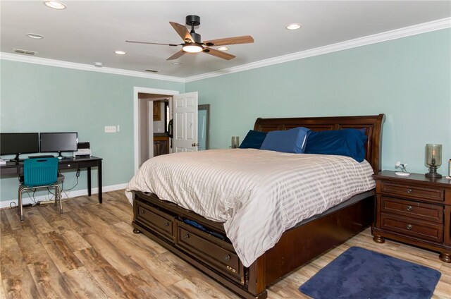 bedroom with light wood-style flooring, visible vents, baseboards, and ornamental molding