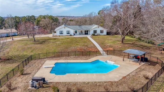 view of swimming pool featuring a yard, fence, and a fenced in pool