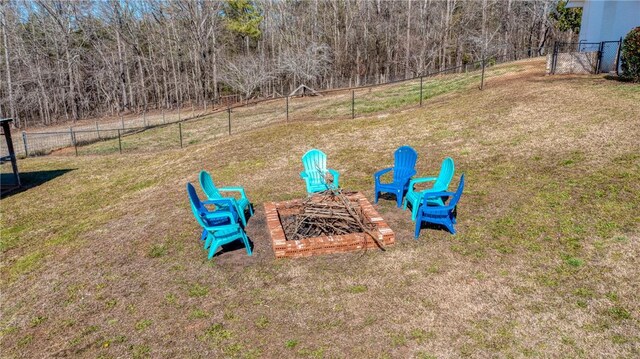 view of yard with an outdoor fire pit and fence