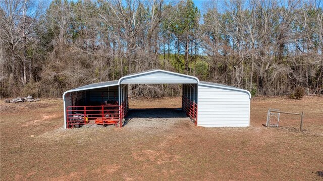 view of outdoor structure with a carport and driveway