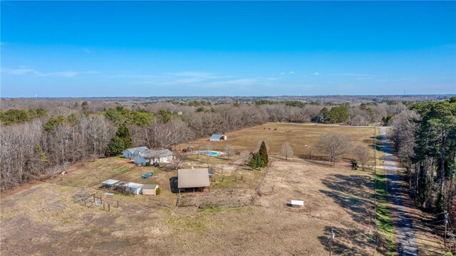 bird's eye view with a rural view and a wooded view