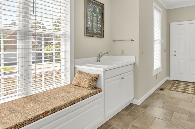 interior space with a sink and baseboards