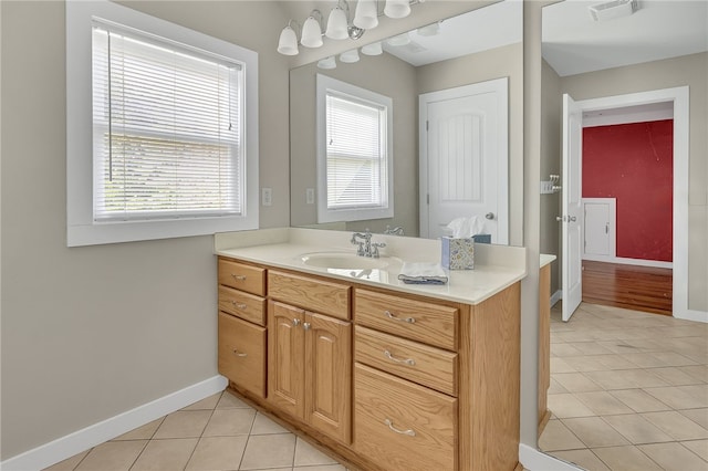 bathroom with tile patterned flooring, visible vents, vanity, and baseboards