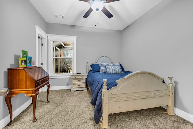 carpeted bedroom featuring a ceiling fan, visible vents, and baseboards