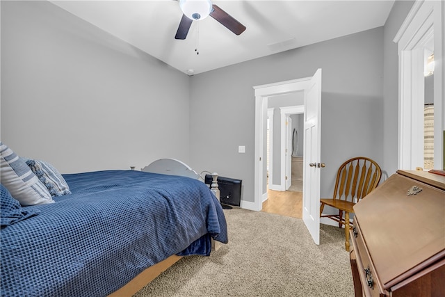 bedroom with ceiling fan, baseboards, and light colored carpet