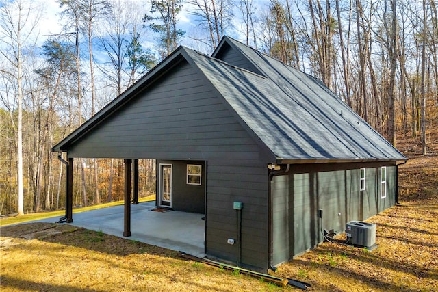 exterior space featuring a lawn, a patio, and central AC unit