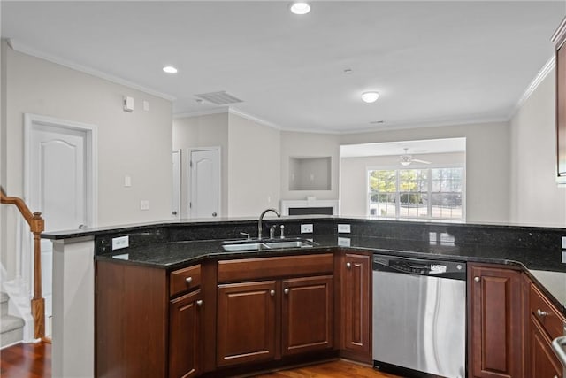 kitchen with crown molding, visible vents, a sink, dark stone counters, and dishwasher