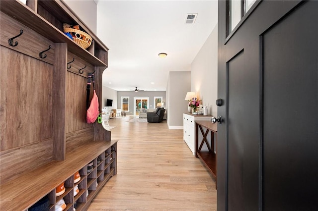 mudroom featuring ceiling fan, light wood-style flooring, visible vents, and baseboards