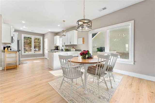 dining room with a notable chandelier, recessed lighting, visible vents, baseboards, and light wood-type flooring