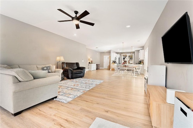 living room with ceiling fan, light wood-type flooring, and recessed lighting