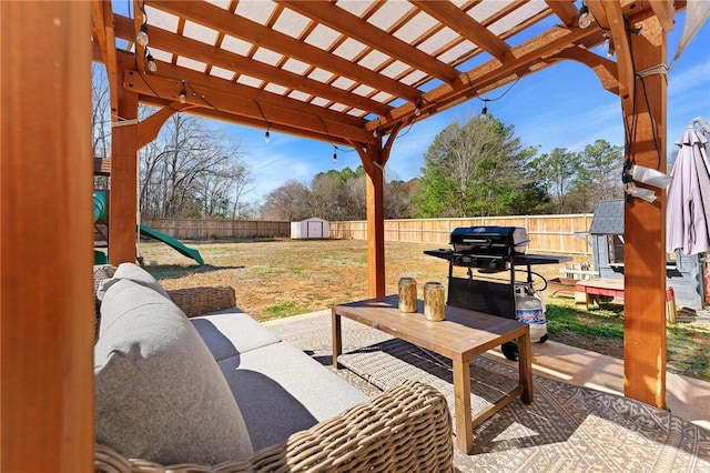 view of patio with an outbuilding, a playground, a fenced backyard, a storage shed, and a pergola