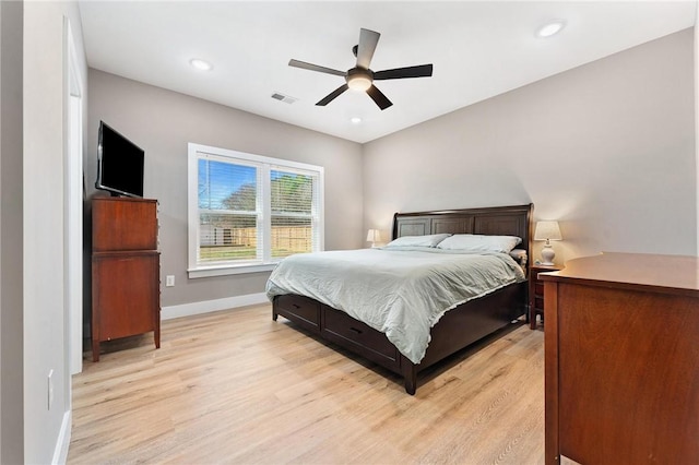 bedroom with light wood-style floors, visible vents, baseboards, and recessed lighting