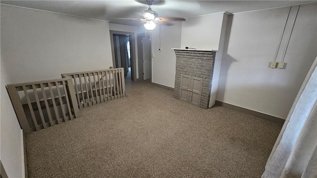 spare room with carpet, baseboards, and a ceiling fan