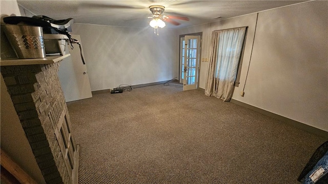 carpeted spare room with ceiling fan and baseboards