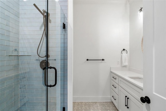 full bathroom featuring ornamental molding, a stall shower, vanity, and baseboards