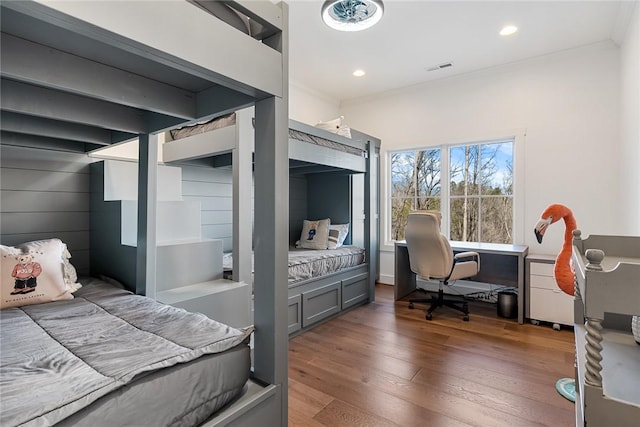 bedroom with ornamental molding, wood finished floors, visible vents, and recessed lighting