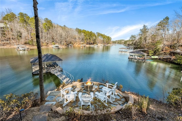 dock area featuring a water view and an outdoor fire pit