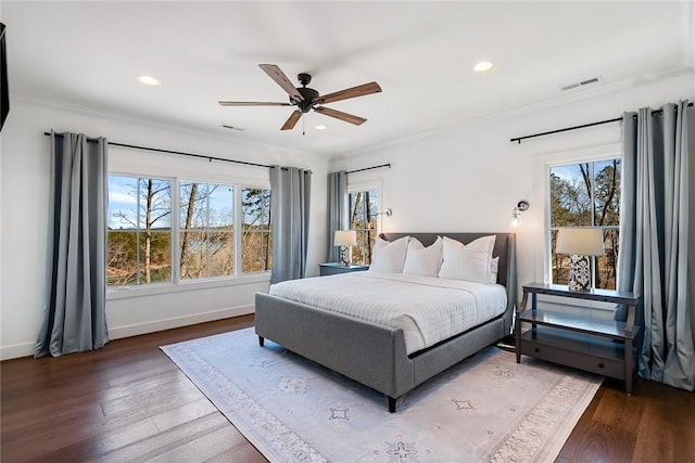 bedroom featuring multiple windows, wood finished floors, and visible vents