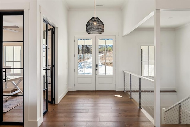 doorway to outside featuring french doors, baseboards, crown molding, and hardwood / wood-style floors