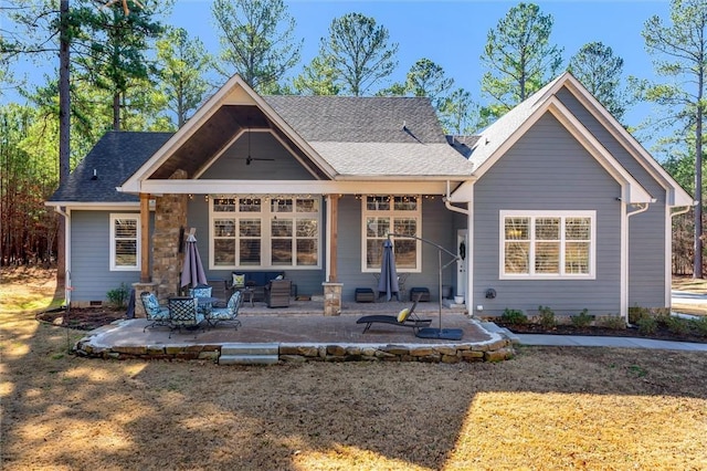 view of front of house with crawl space, roof with shingles, and a patio